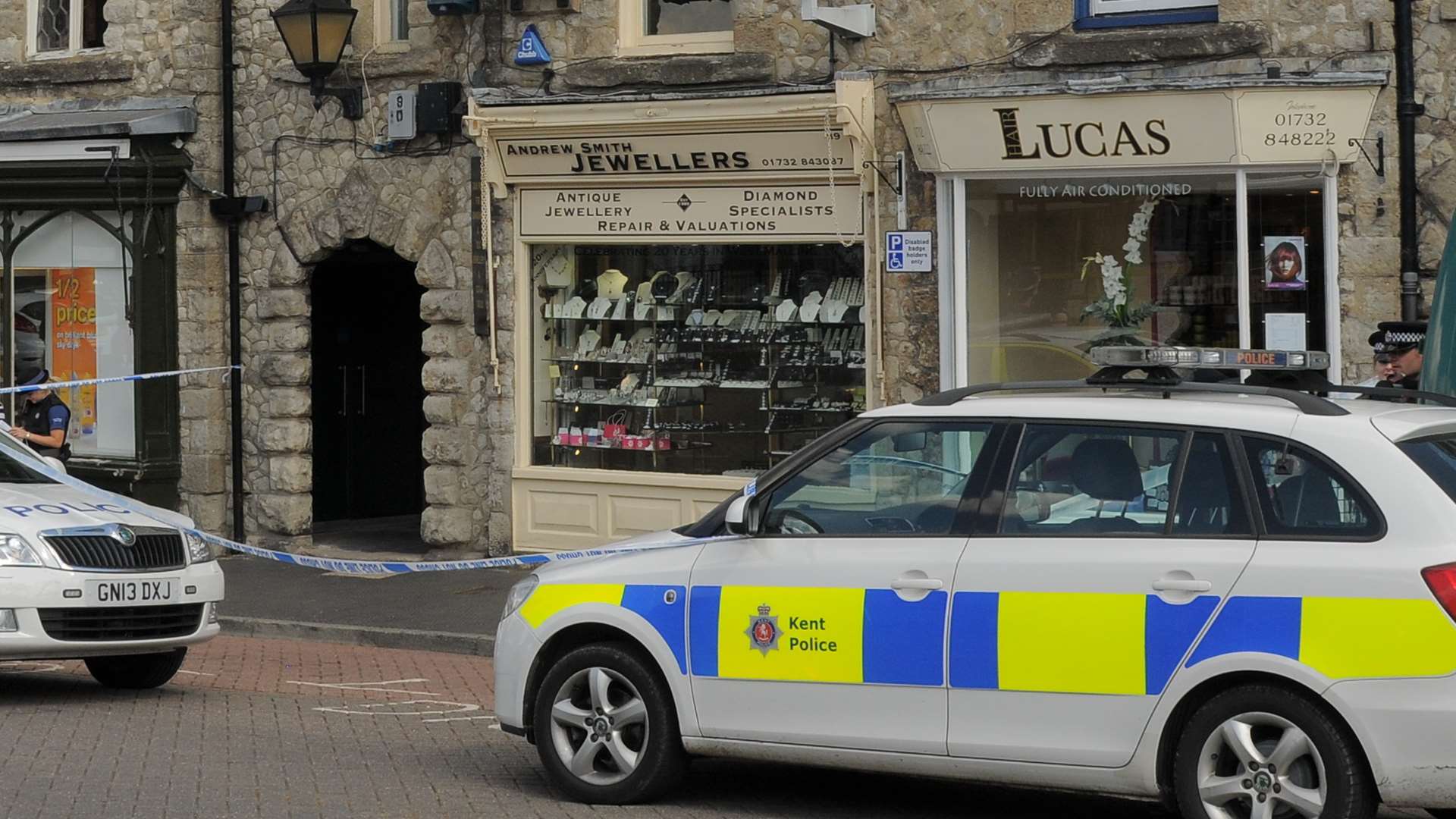 Armed robbers targeted Andrew Smith Jewellers, which is next to Lucas Hair in West Malling High Street, in 2013.