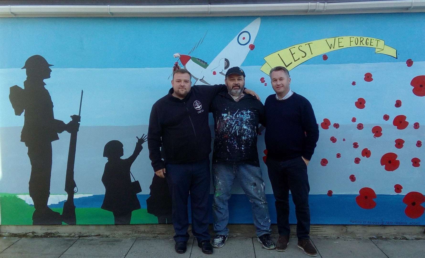 Artist Richard Jeferies with undertakers Bobby Palliser and Stephen Platt of Palliser Platt and Sons and the mural for Remembrance Sunday in Sheerness