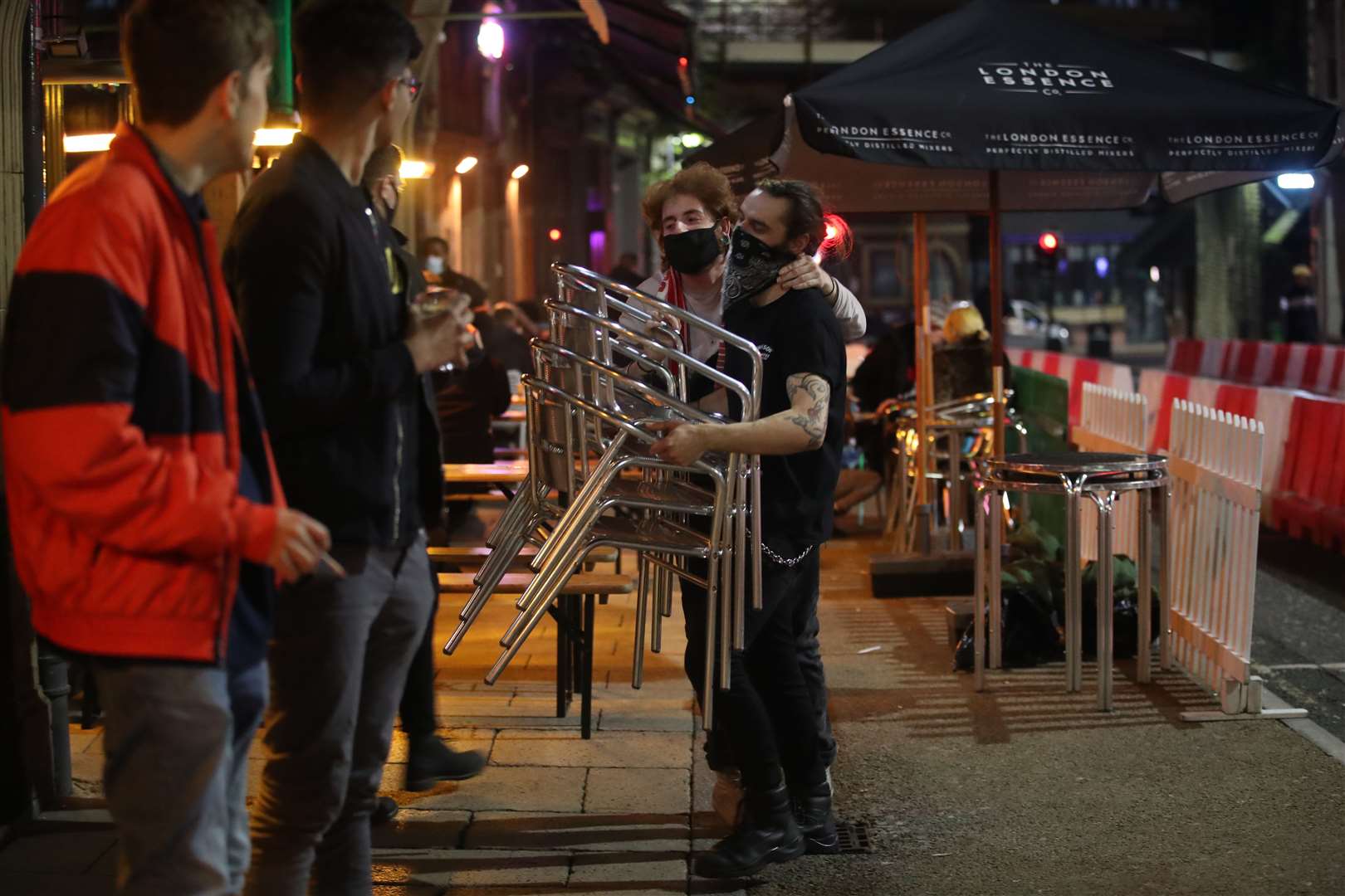 A man puts away chairs outside a bar in Leeds city centre, ahead of a national lockdown for England from Thursday (Danny Lawson/PA)