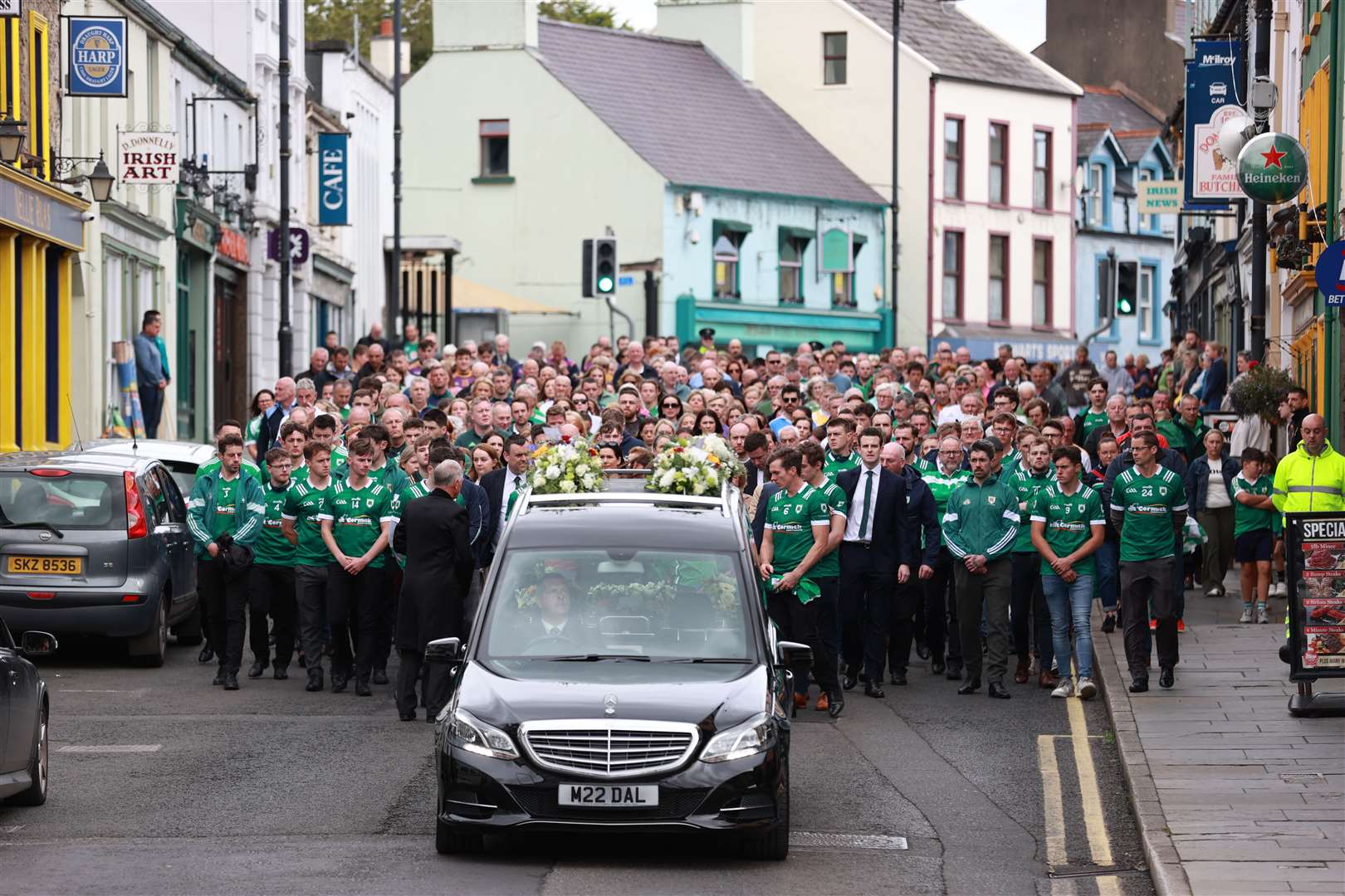 Mourners walk beside the hearse as the cortege travels to the funeral of Joseph Hegarty at St Patrick’s and St Brigid’s Church, Ballycastle, Co Antrim (Liam McBurney/PA)