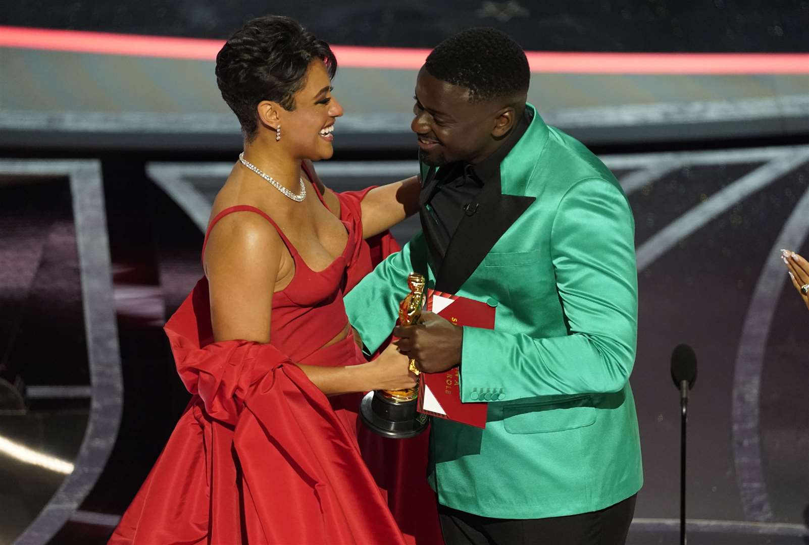 Ariana DeBose collects her gong from Daniel Kaluuya (Chris Pizzello/AP)