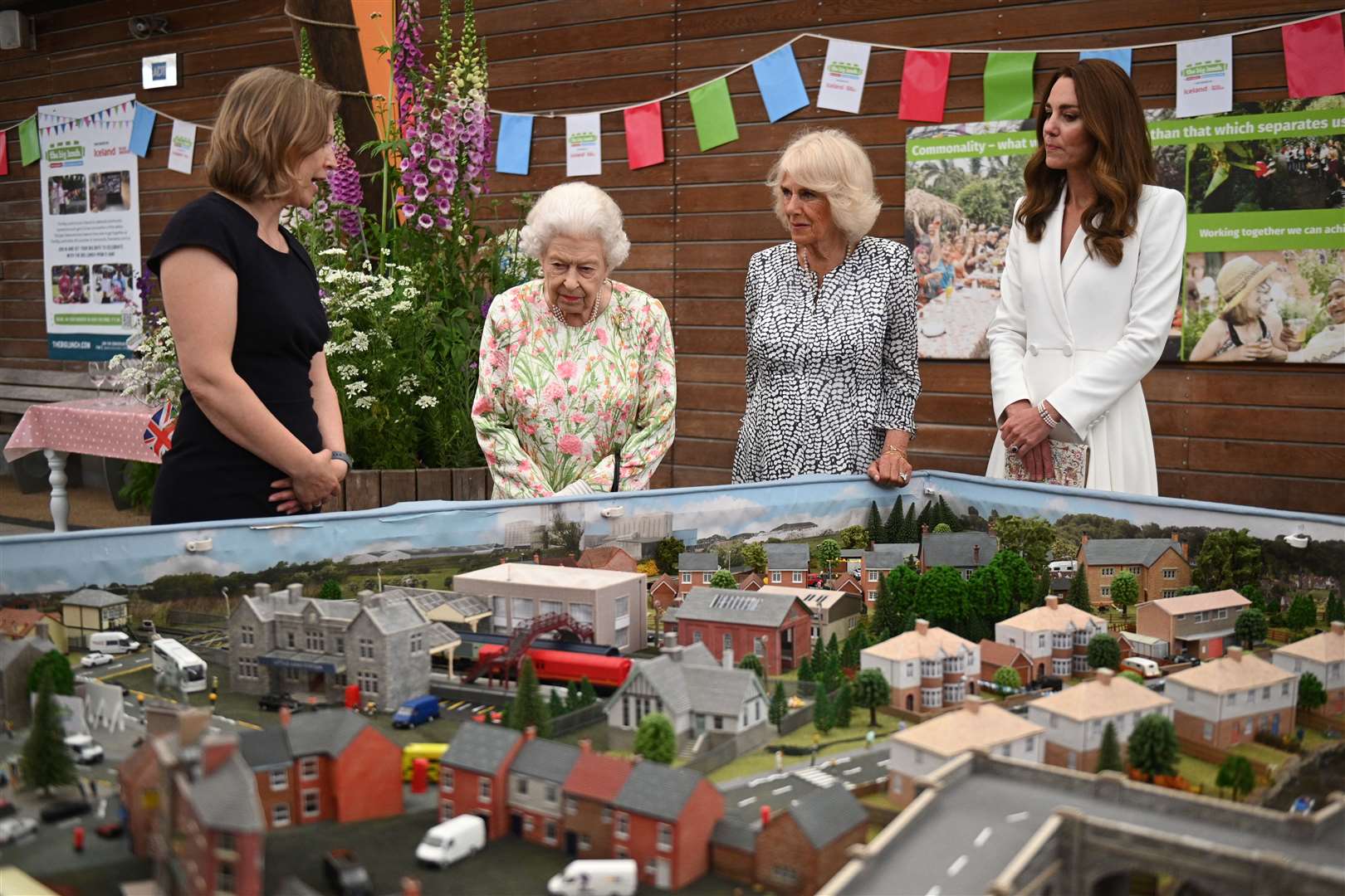 Programme director at the Eden Project, Lindsey Brummitt, shows a scale model of Big Lunch events to the royals (Oli Scarff/PA)