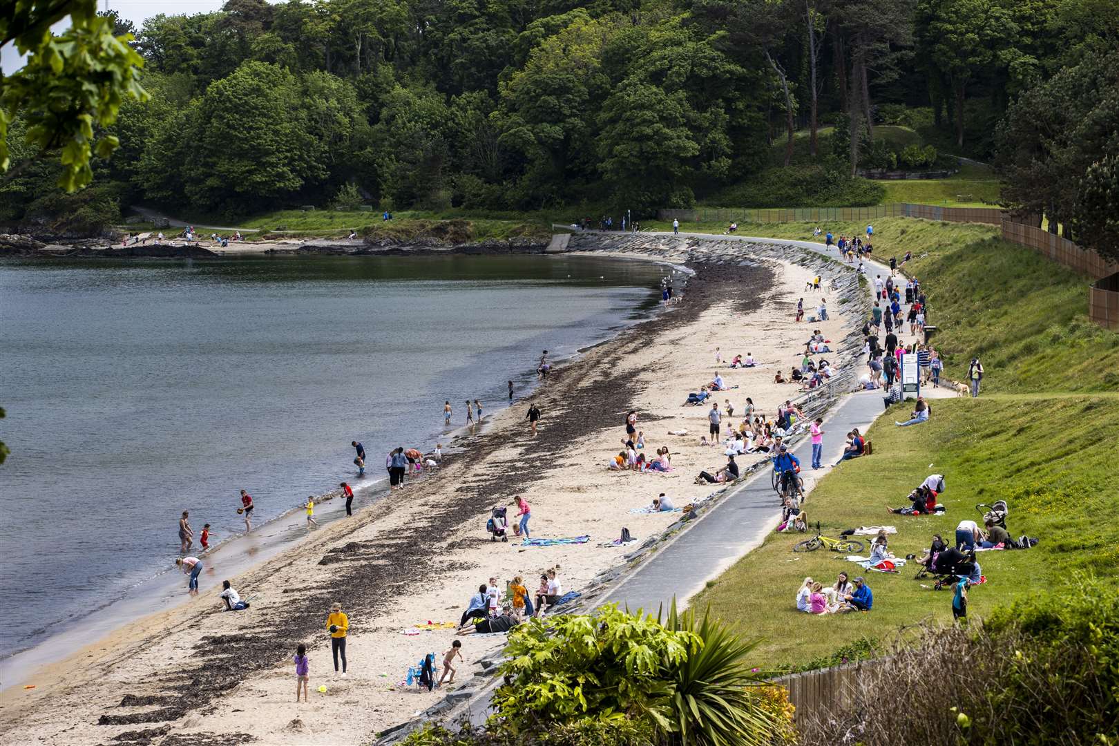 Crowds gather at the beach and along the footpath at Helen’s Bay in Co Down (Liam McBurney/{PA)