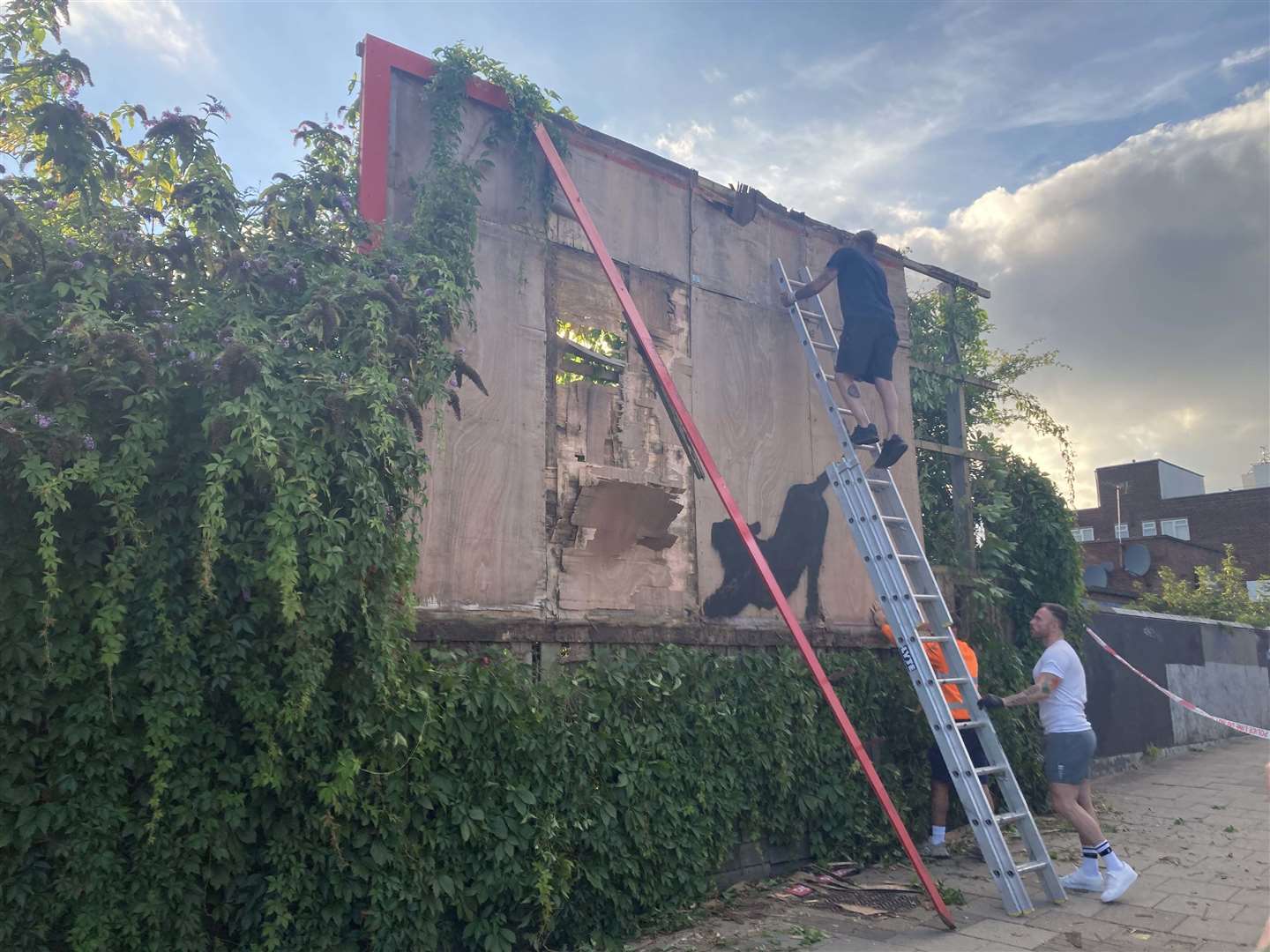 Contractors dismantled a billboard in Cricklewood, north-west London, with a Banksy artwork ‘for safety reasons’ (Jordan Reynolds/PA)