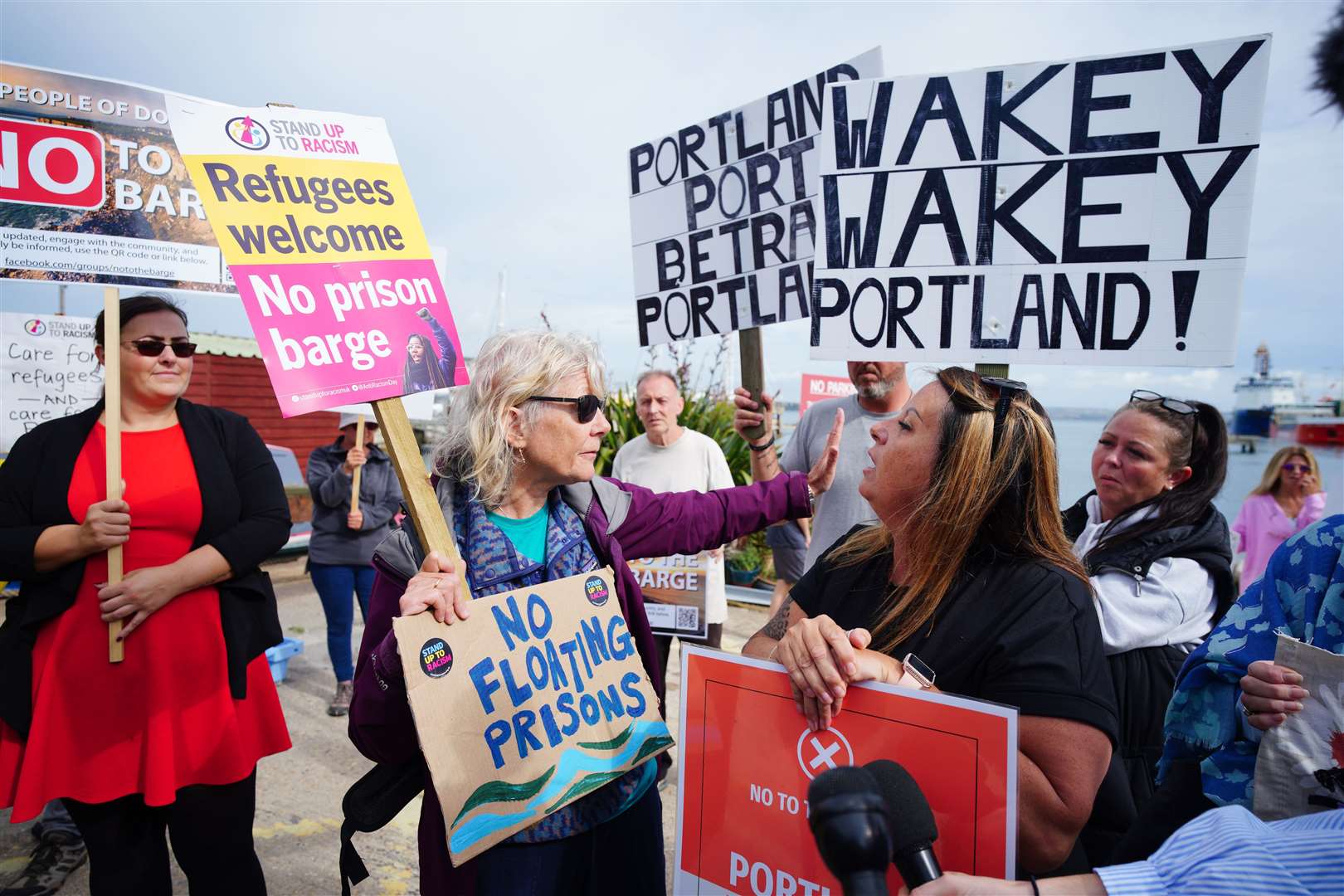 Rival protesters argue in Portland in Dorset after the Bibby Stockholm accommodation barge arrived from dry dock in Falmouth, Cornwall (Ben Birchall/PA)