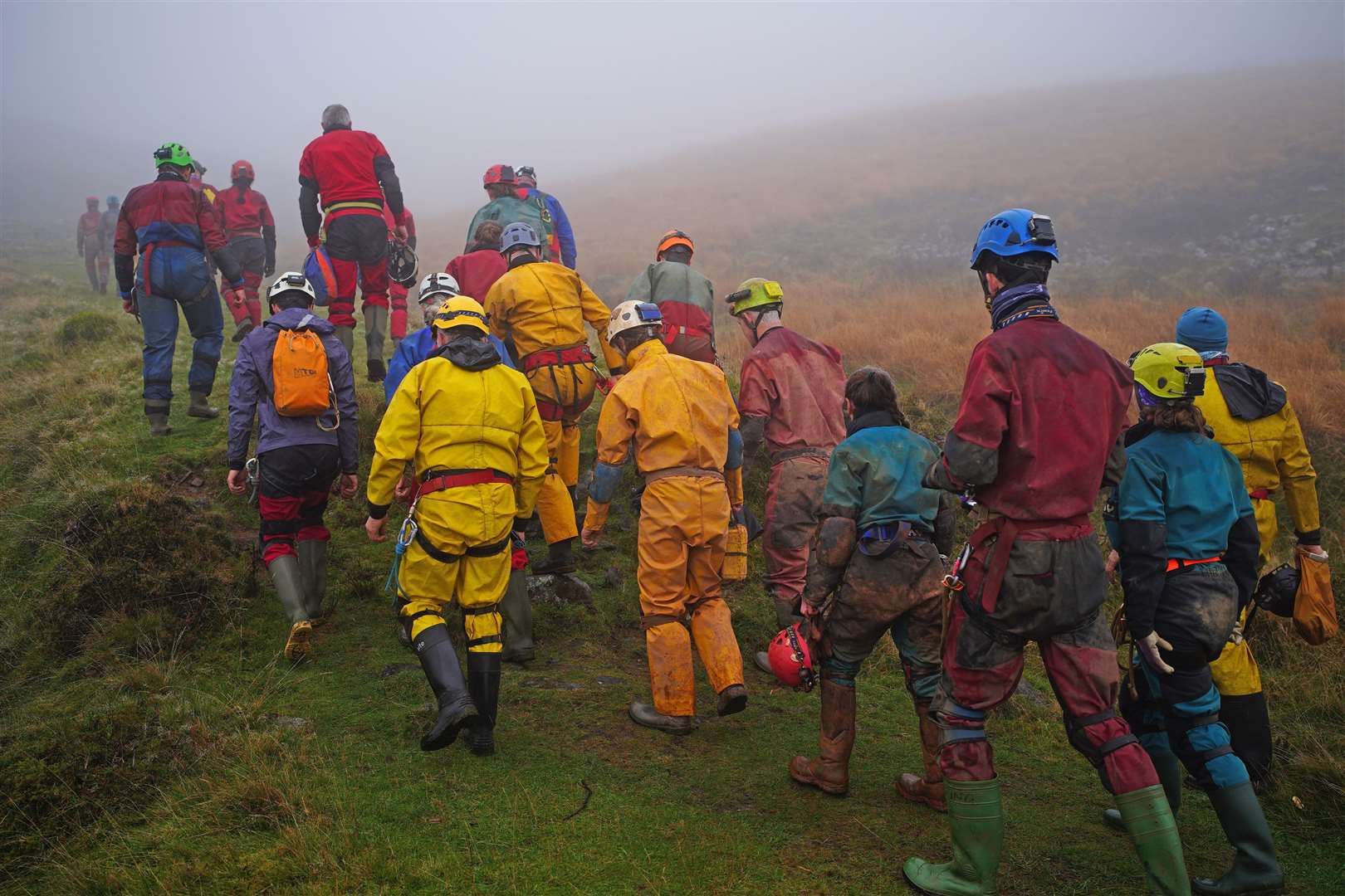 Rescuers walk towards the Ogof Ffynnon Ddu cave system (Ben Birchall/PA)