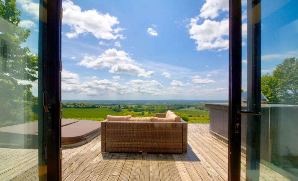 The outside decking has seating and an outdoor kitchen