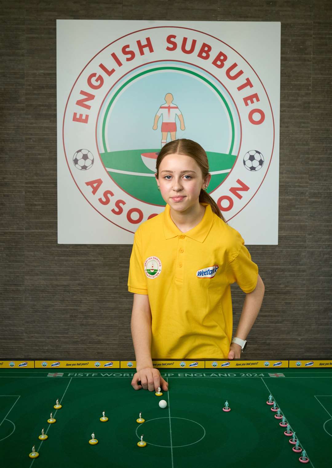 Ruby Matthews from Flintshire, Wales, plays the tabletop game in which players use miniature footballers to flick a ball around a table (Simon Jacobs/PA)