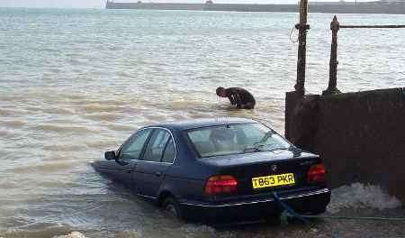 The car being towed out of the sea. Picture: GRAHAM TUTTHILL