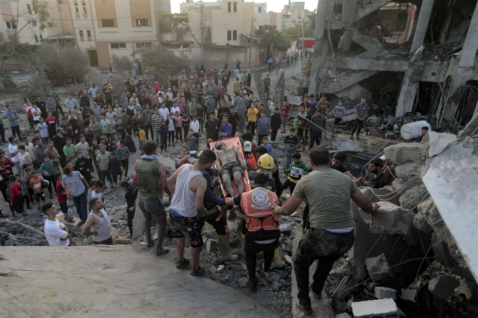 Palestinians evacuate a survivor from a destroyed house hit by an Israeli air strike in town of Khan Younis, southern Gaza Strip (Mohammed Dahman/AP/PA)