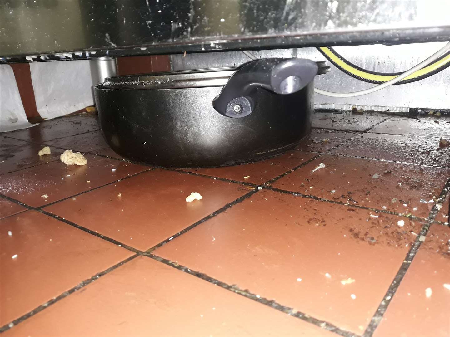 Food, grease and oil were found beneath the cooking range