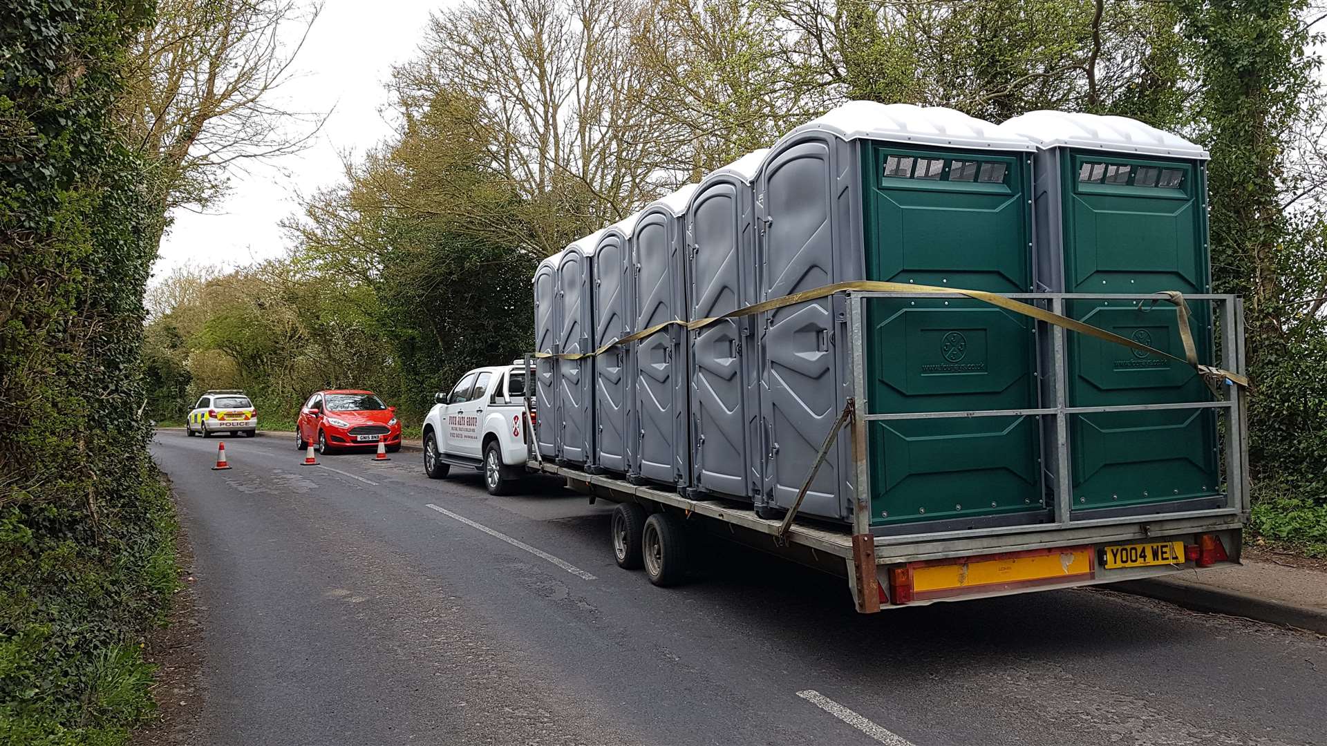 A dozen portable toilets arrive in Aylesham Road, suggesting officers will be at the scene for some time