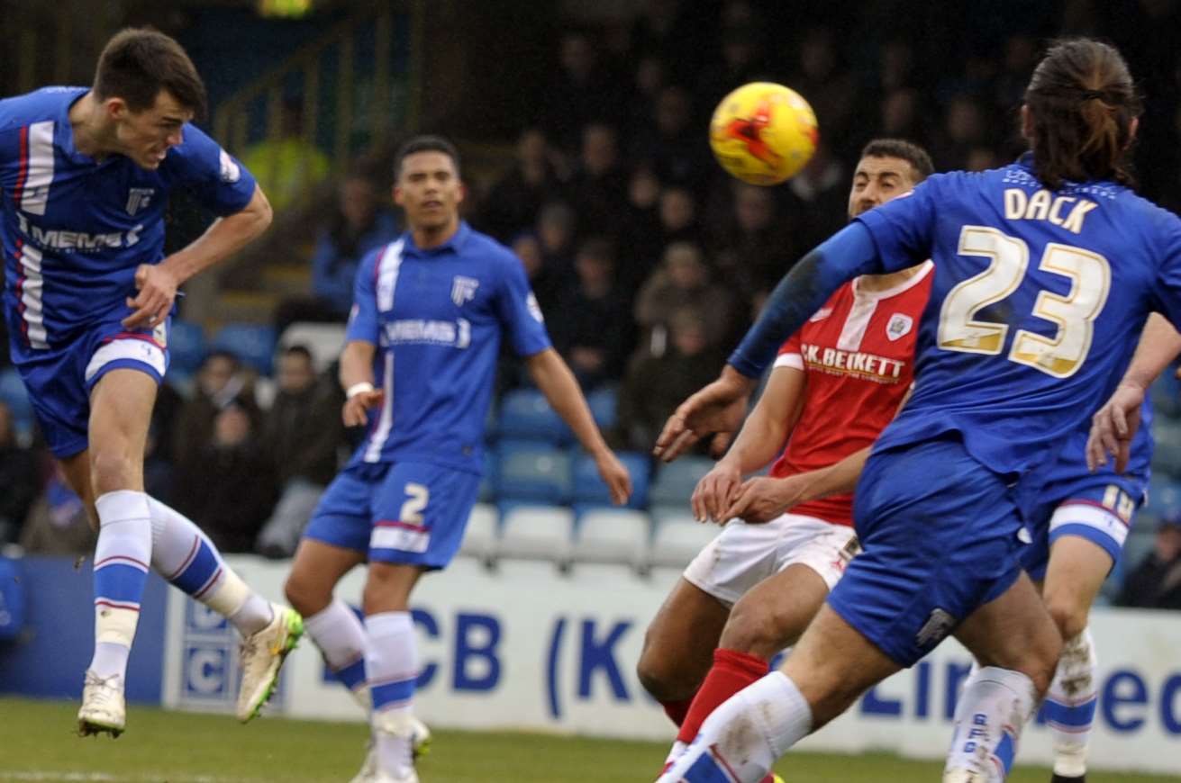 John Marquis heads goalwards during Gillingham's defeat at home to Barnsley Picture: Barry Goodwin