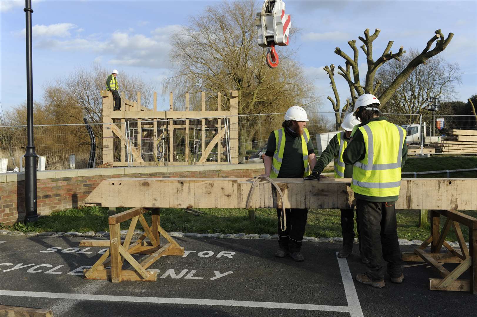 The frame of a building to store a medieval ship being erected.