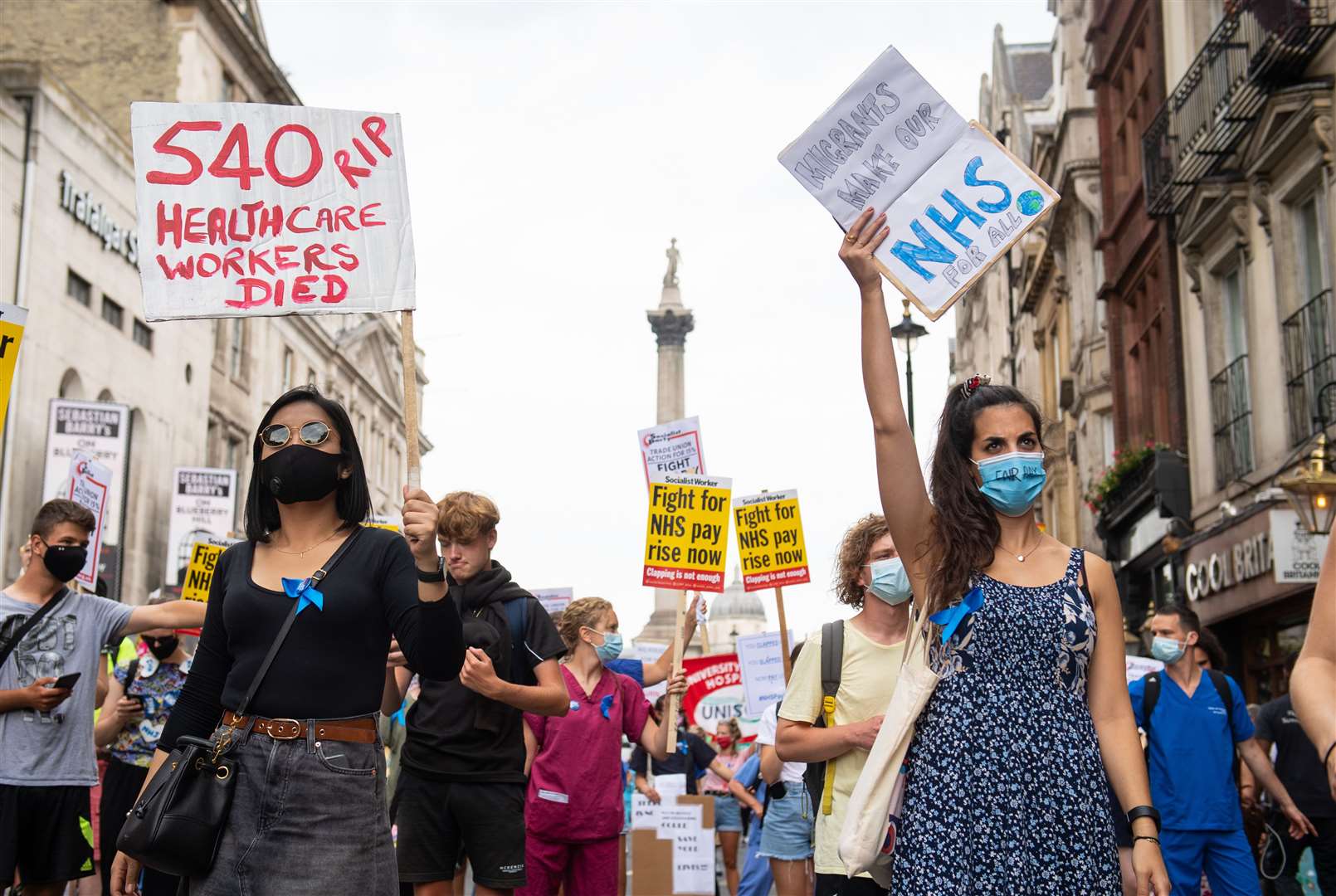 NHS workers march along Whitehall (Dominic Lipinski/PA)