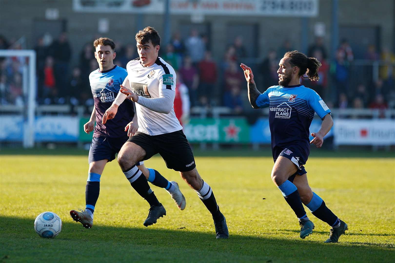 Dan Johnson takes the ball away from two Woking players Picture: Andy Jones