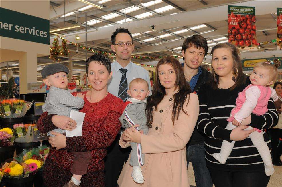 Sheerness Times Guardian Cute Kids' winners Finley Judges and mum Emma, Archie Wood and mum Emma, Tommy Nichol, Amy Dummott and Skye Nichol with Morrisons' deputy manager Darrel Smith