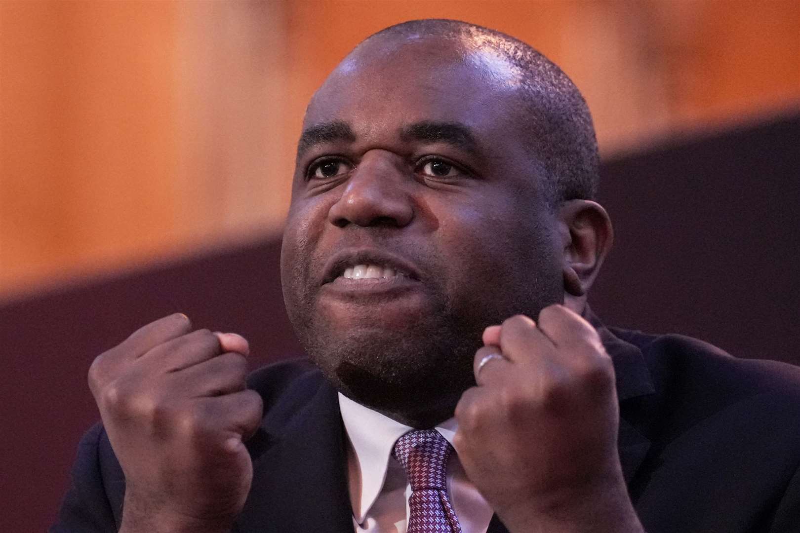 David Lammy makes a fist of it as he continues with his speech at the Fabian Society in London despite protesters trying to interrupt him (Maja Smiejkowska/PA)