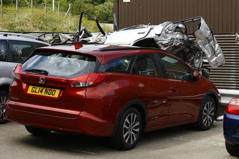 A red car is damaged in the crash, off the A20 in Dover at the Megger car park