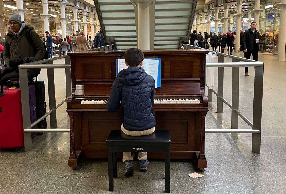 Jesse Bradley, 13, playing at London St Pancras to raise money for his local food bank in Gravesend. Photo: Kathleen Bradley