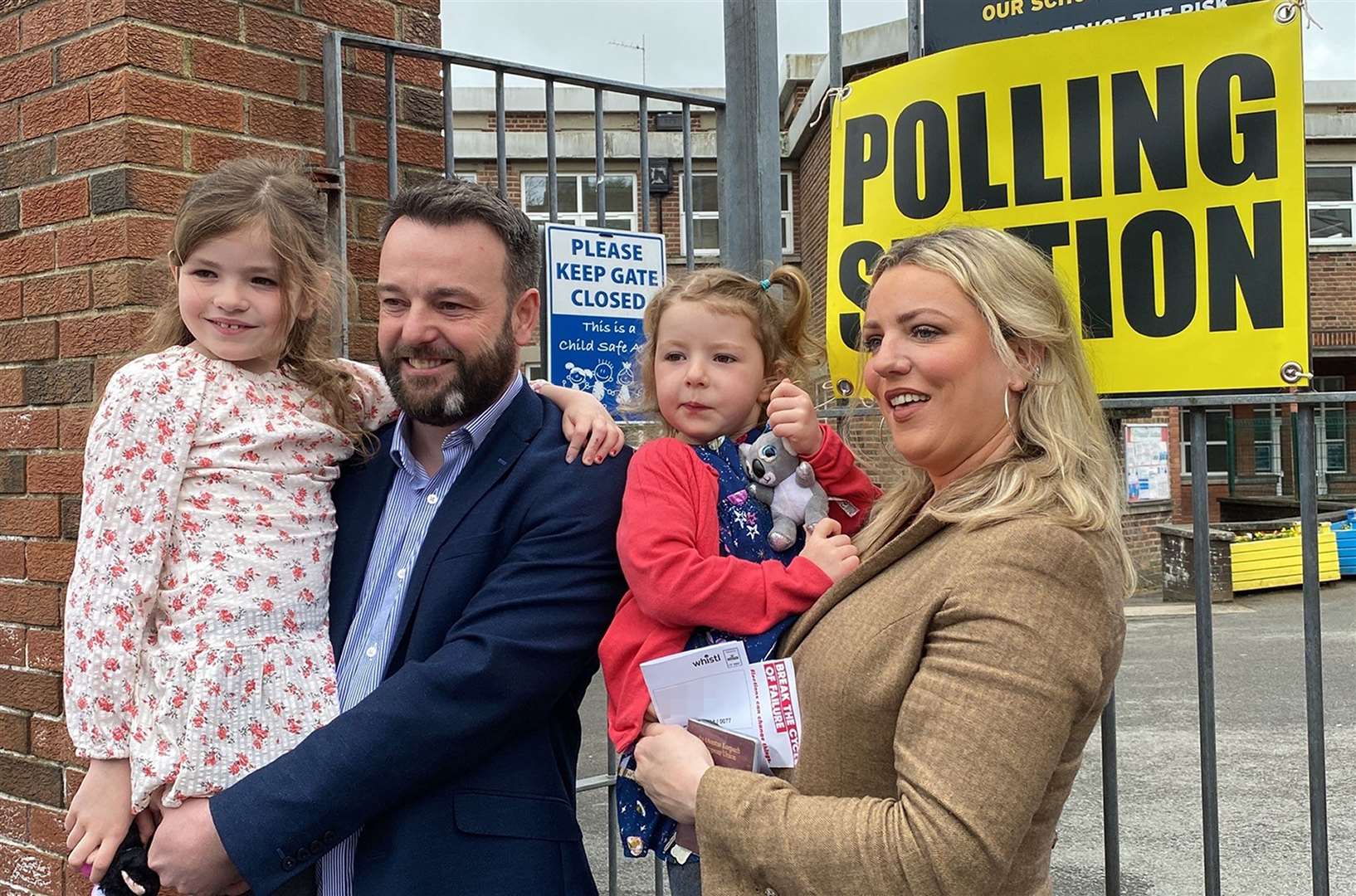 SDLP leader Colum Eastwood arrives to cast his vote in the 2022 NI Assembly election with his wife Rachael and children, Rosa, six, and Maya, four, in the Foyle constituency in Londonderry (PA)