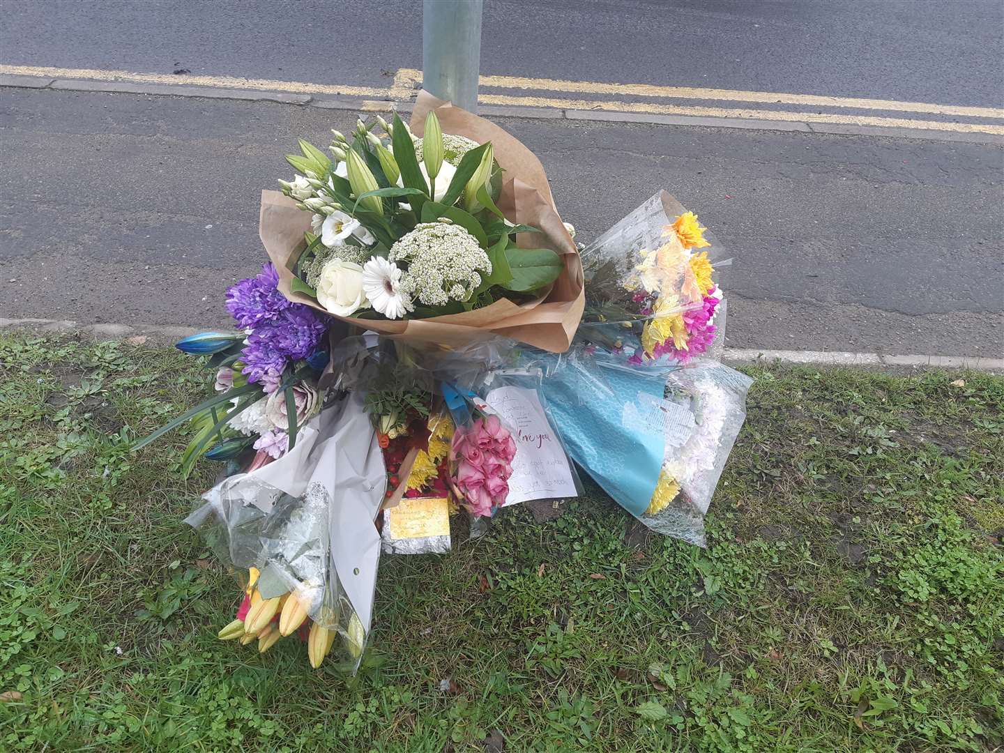 Floral tributes near the spot of the fatal collision on Medway City Estate