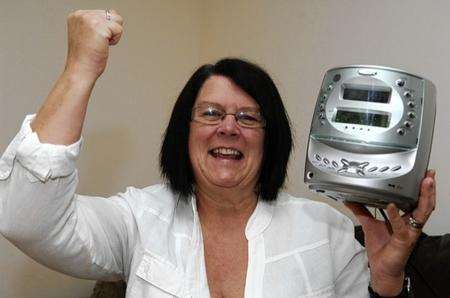 Patricia Hunt celebrates winning a family holiday to Kissimmee on KMFM