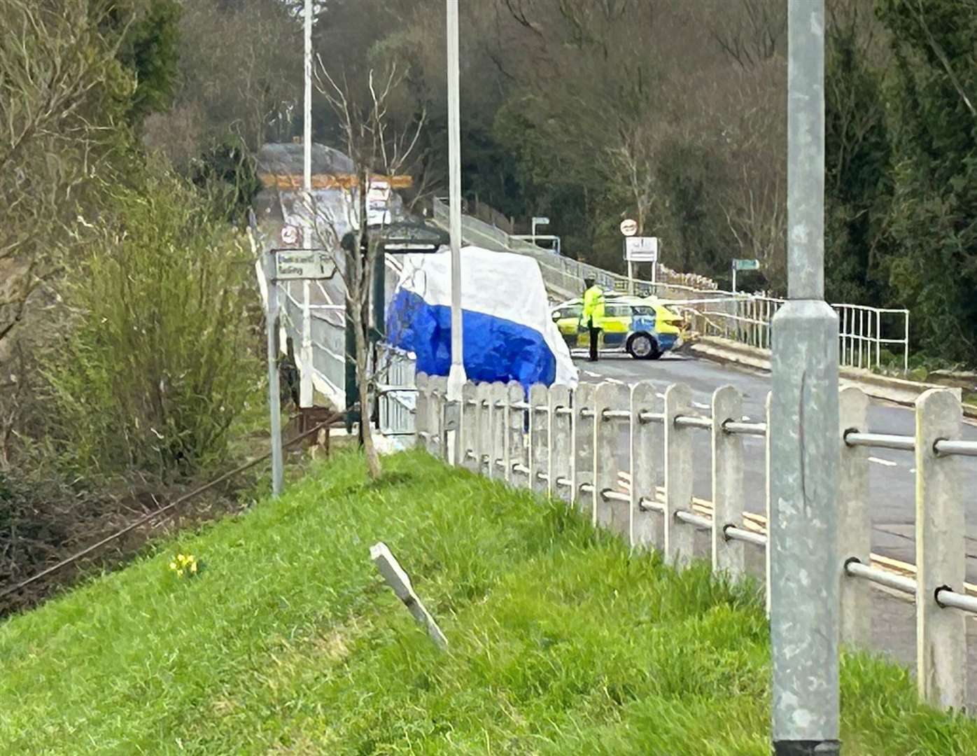 A tent was erected near a bus stop in the village, where Adam Pritchard collapsed and died