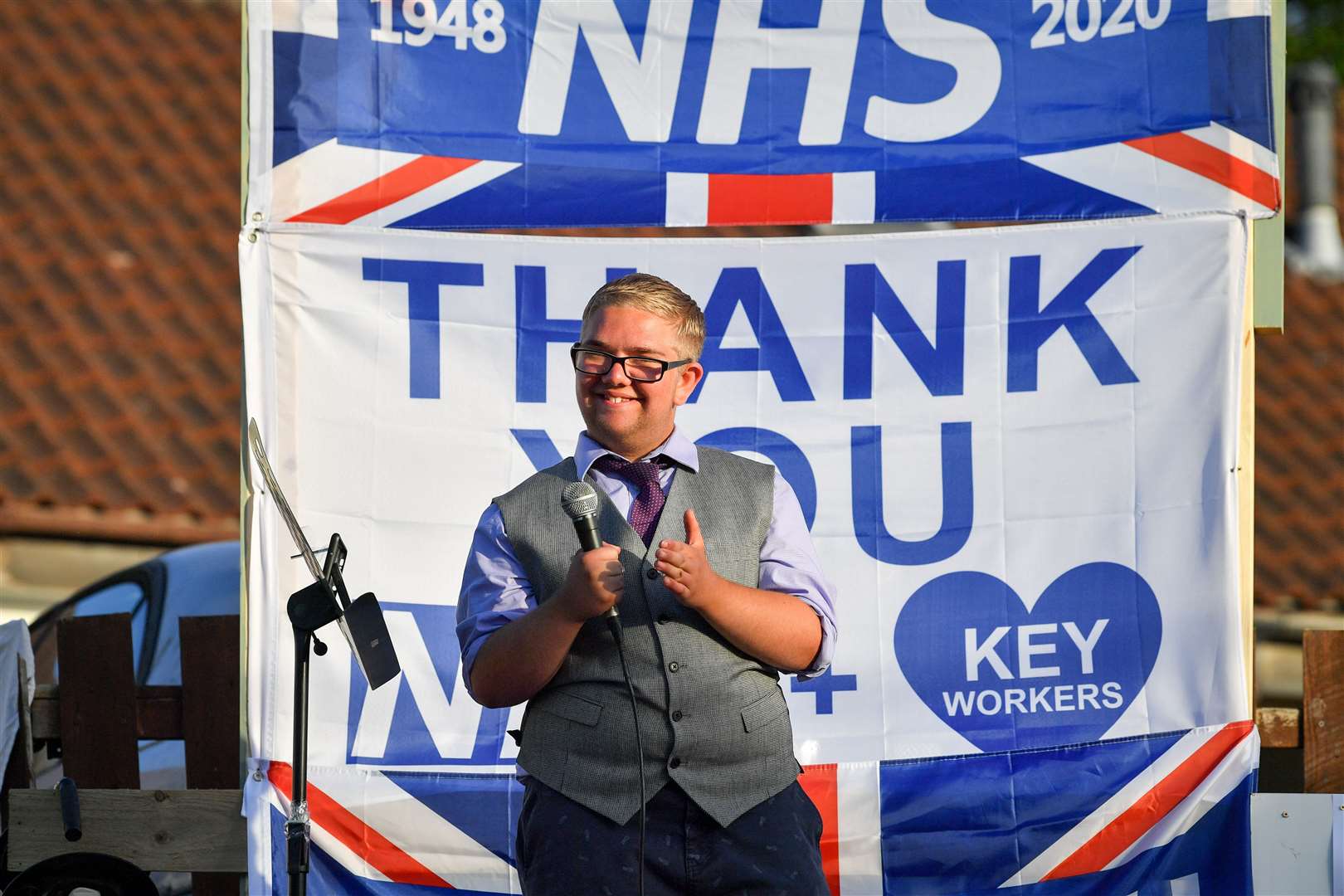 Joshua Morton outside his home in the St George area of Bristol. Josh, 15, sets up a stage in the front garden of his home and performs for his neighbours before and after the weekly Clap for Carers, raising money for the Grand Appeal to support Bristol Children’s Hospital (Ben Birchall/PA)