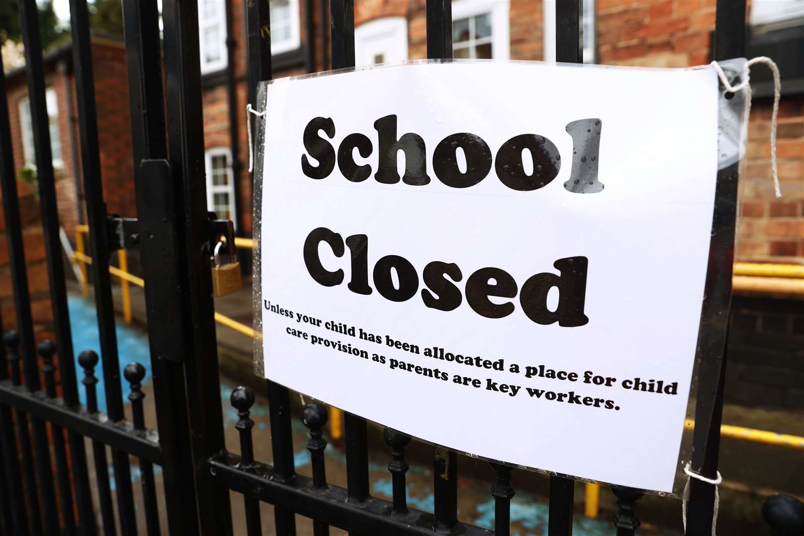 A sign on the gates of a closed school (Tim Goode, PA)