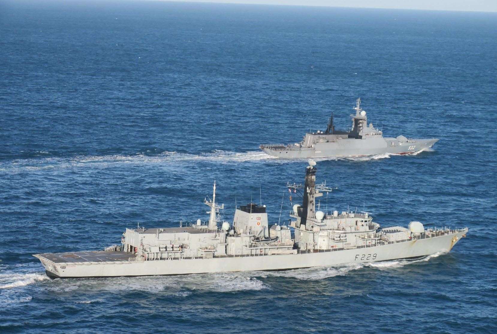 Handout photo issued by the Ministry of Defence (MoD) of the Russian corvette Boikiy (back) which was shadowed by HMS Lancaster as it sailed in waters around the UK (MoD/PA)