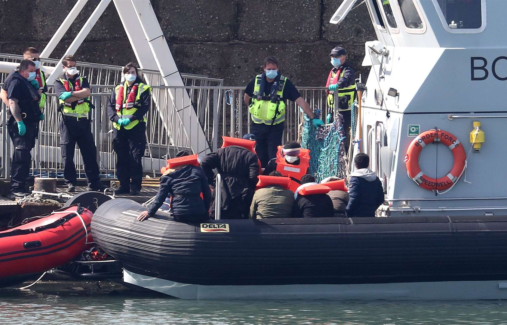 Border Force officers preparing to bring to shore men thought to be migrants in Dover (Gareth Fuller/PA)