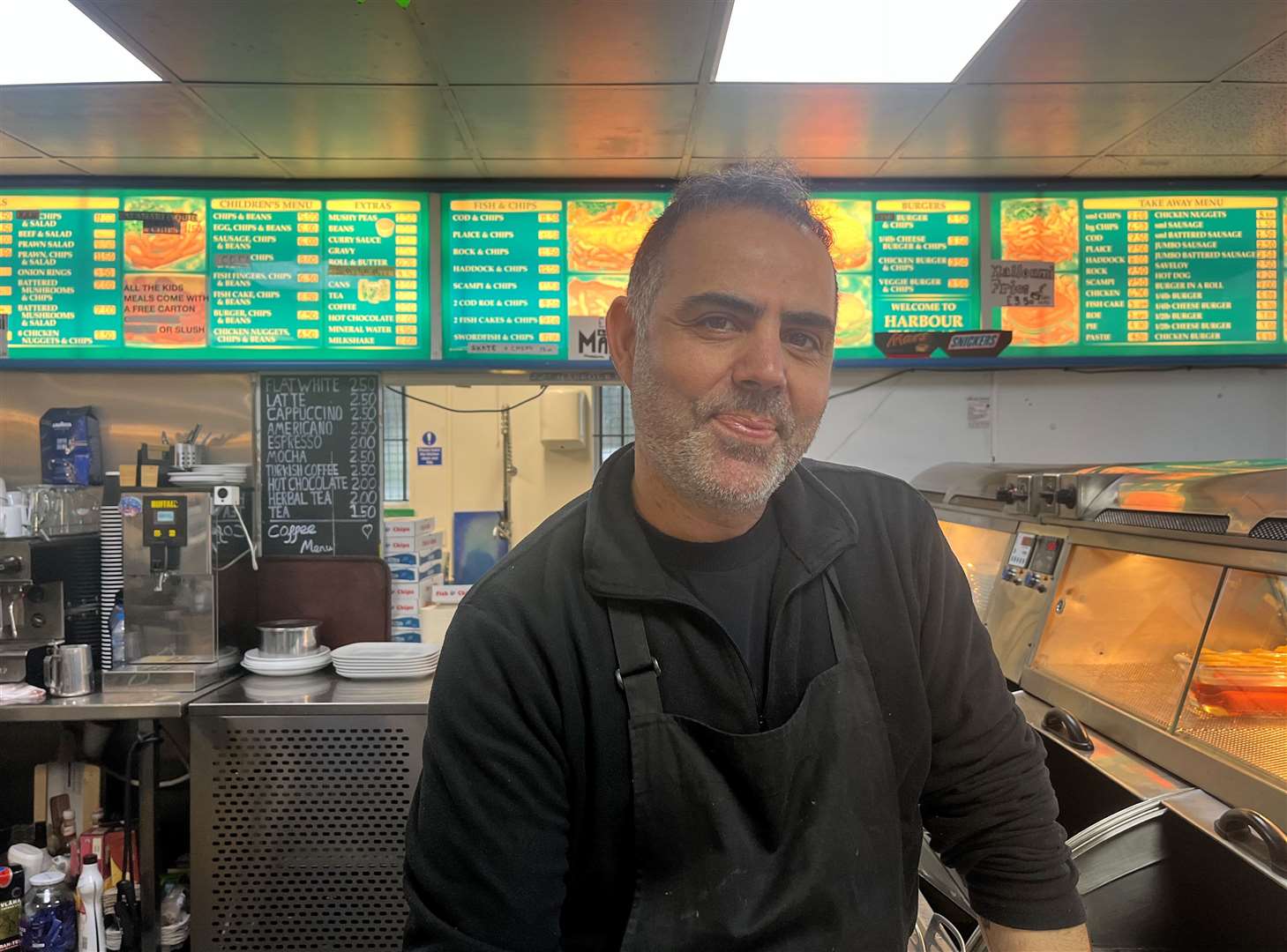 Harbour Fish Bar manager Murat Karakartal will remain open despite the landslides behind the restaurant.