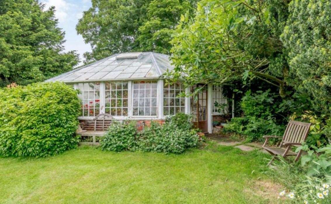 The cottage garden features a greenhouse. Picture: Strutt & Parker