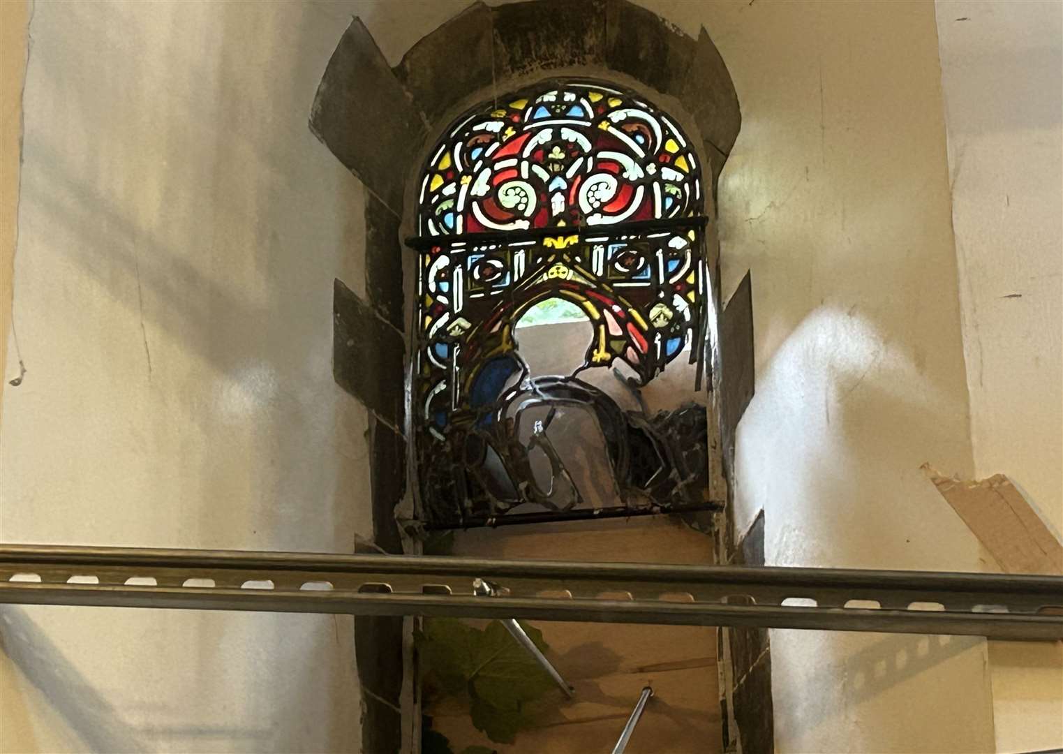 A smashed stained glass window at St Bartholomew's Hospital Chapel in Gundulph Road, Rochester