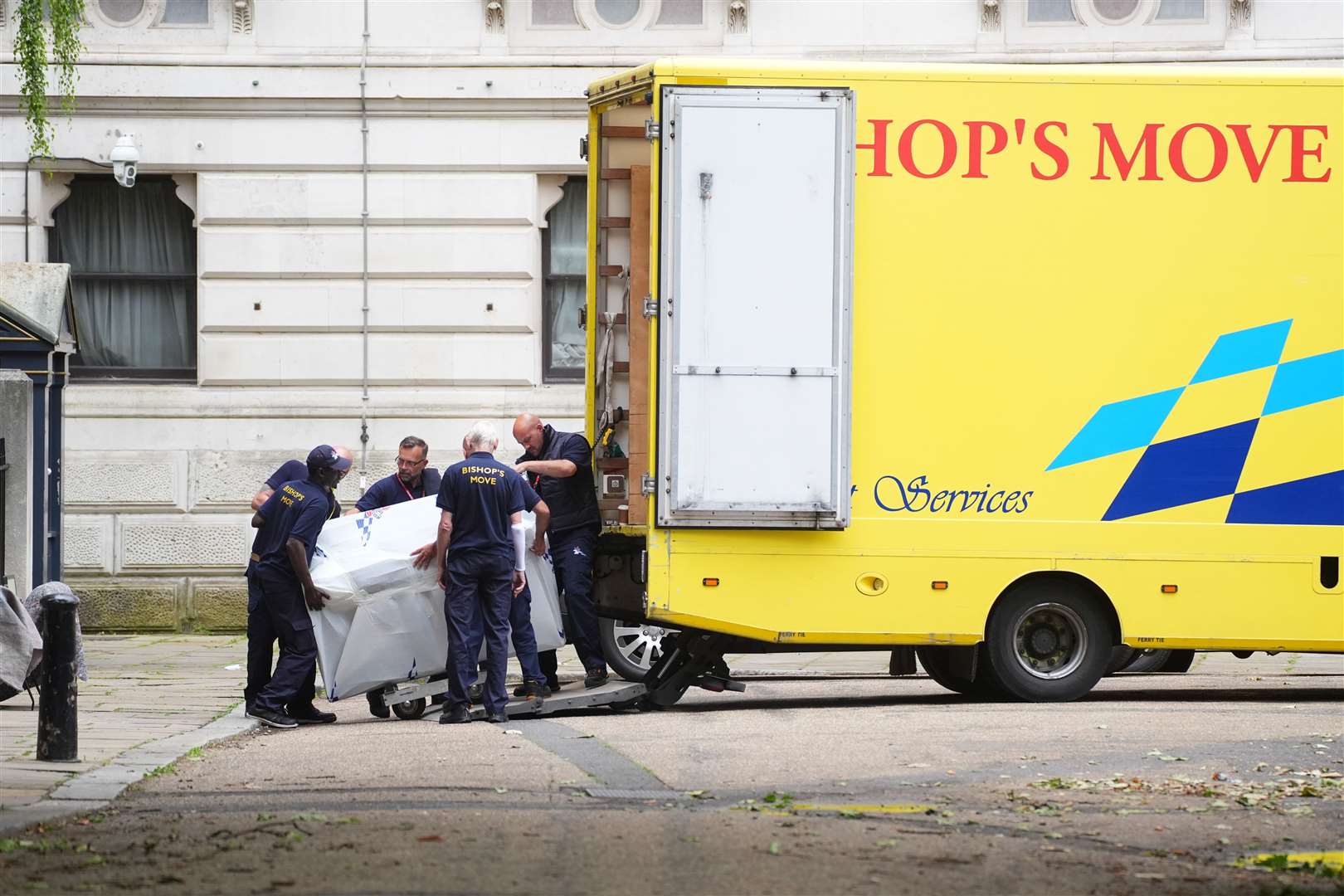 Removal men load an upright piano into the van at the back of Downing Street (James Manning/PA)