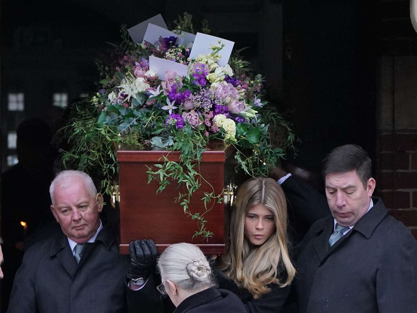 Pall bearers, including Darcey, carry the coffin out of the funeral service of Derek Draper (Jonathan Brady/PA)