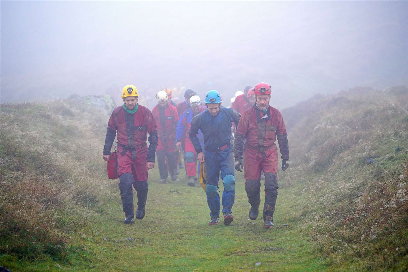 Rescuers walk towards the Ogof Ffynnon Ddu cave system near Penwyllt, Powys, in the Brecon Beacons, Wales (Ben Birchall/PA)