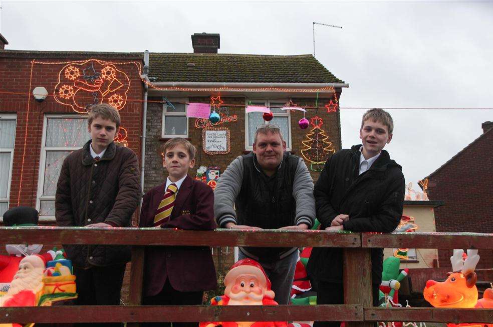 Darran Wright and his sons Declan and Dayton, both 15, and William, 12, outside the front of their home