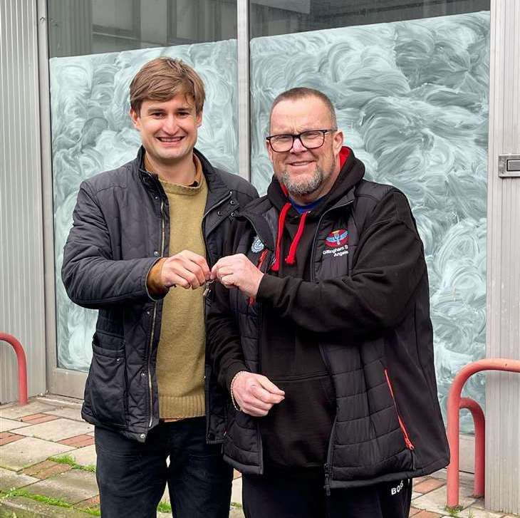 Neil Charlick, right, picks up the keys to former Grays car showroom from director Peter Gray