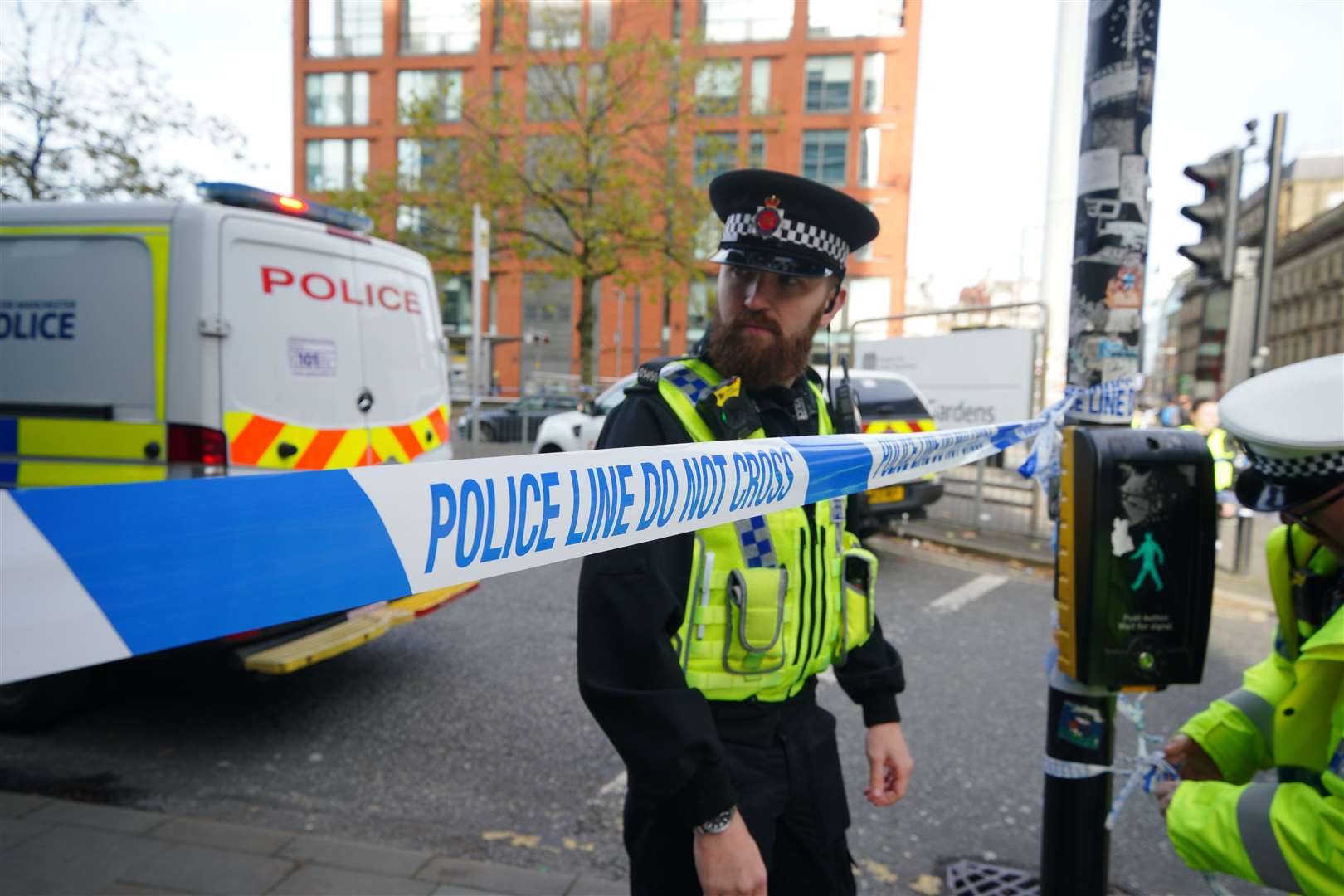 Police officers at the scene of a bus crash at the City Tower building close to Manchester’s Piccadilly Gardens Metrolink stop (Peter Byrne/PA)