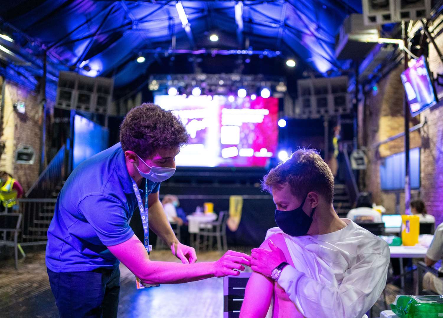 Chris Jordan receives a dose of the Pfizer/BioNTech covid vaccine at Heaven nightclub in central London (Dominic LIpinski/PA)