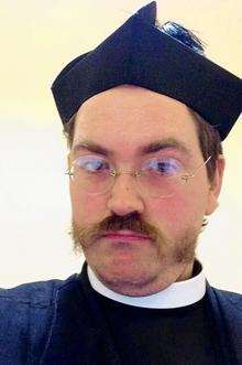Chris Cooper, who was escorted from St Mary's Church by police after dressing up as a vicar and protesting.