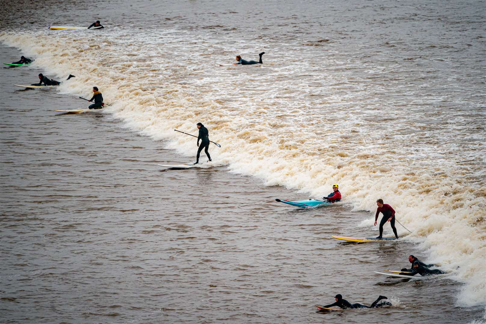 Surfers ride the Severn Bore at Newnham (Ben Birchall/PA)