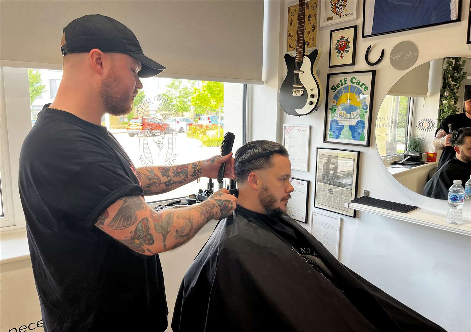 Barber Jake Cox and customer Dean Kalinka at No Bad Days barbershop in St Mary's Island, Chatham