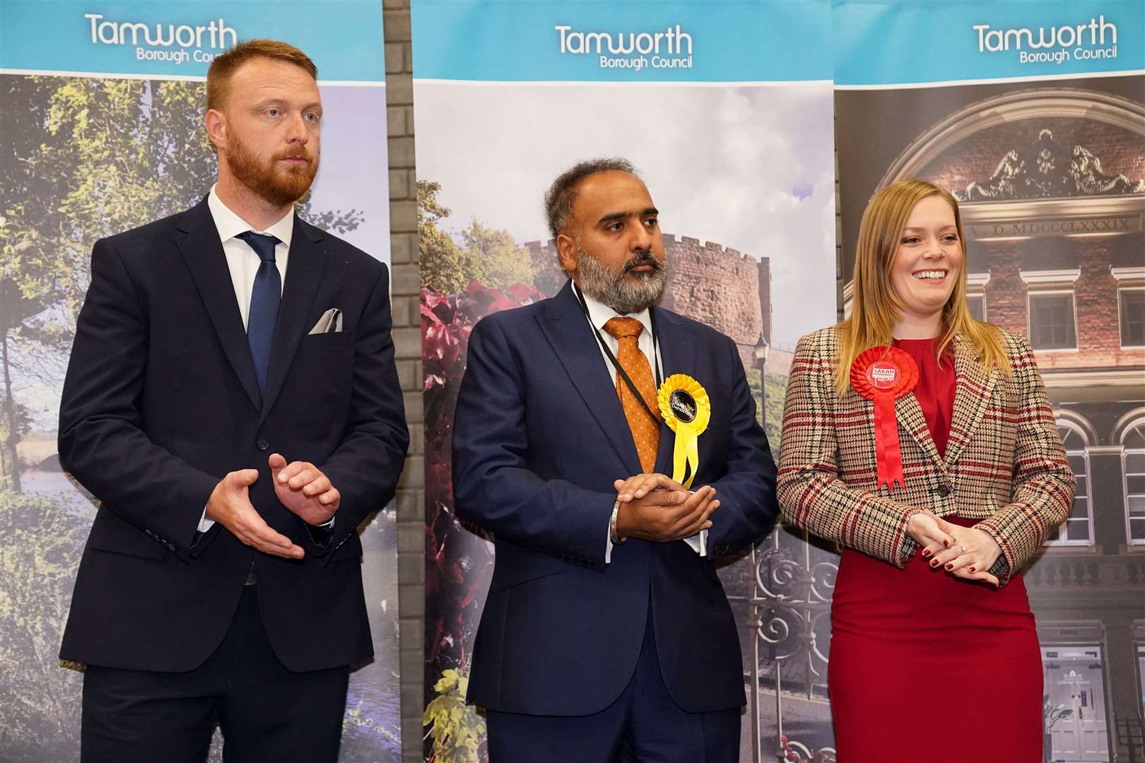 The Tory candidate, Andrew Cooper, left, was ushered out of the school hall where the results were declared seconds after his defeat was confirmed (Jacob King/PA)