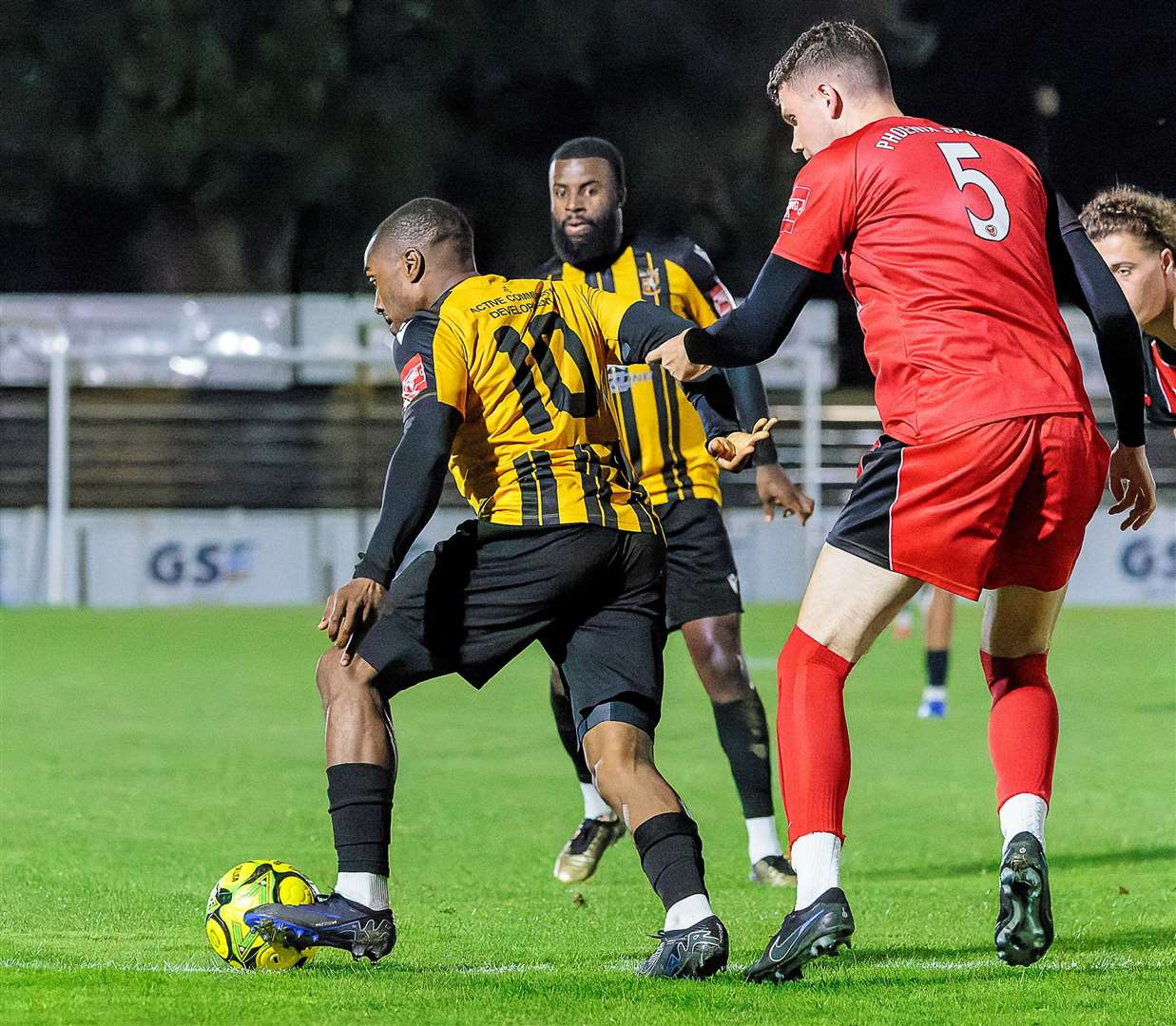 New signing Matthias Fanimo on the ball for Folkestone as Phoenix Sports defender Sam Huckle puts him under pressure as Invicta exited the Kent Senior Cup last Tuesday. Picture: Helen Cooper