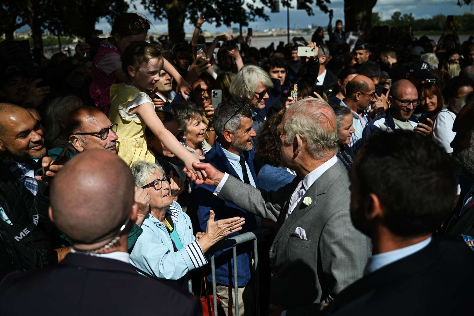 The King shook hands with members of the public who had gathered at the festival to see him and the Queen (Daniel Leal/PA)