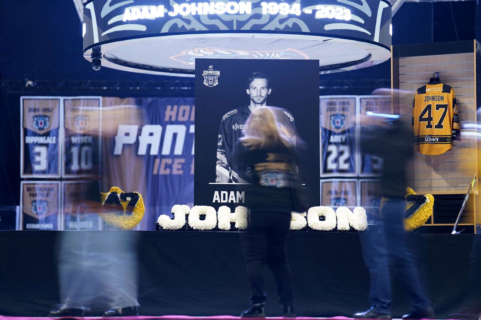 People queue to sign a book of condolence as they attend a memorial for Adam Johnson at the Motorpoint Arena in Nottingham (Zac Goodwin/PA)