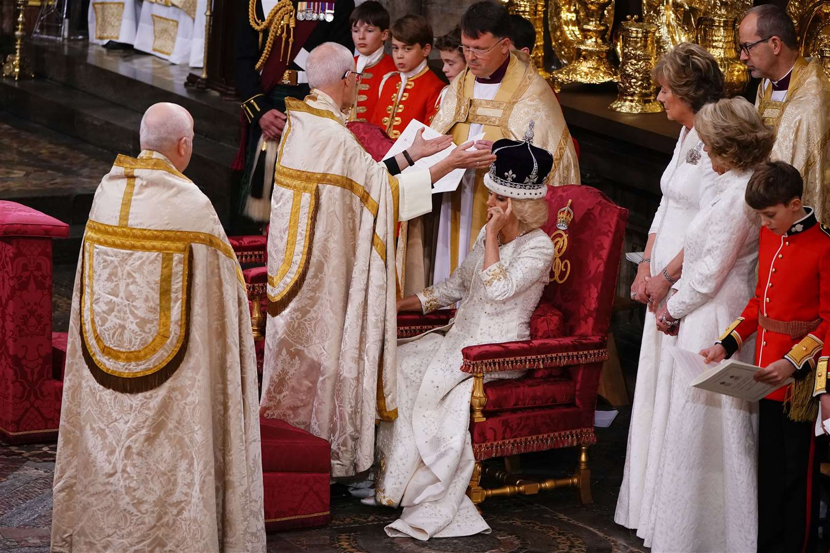 Queen Camilla adjusts her hair after receiving Queen Mary’s Crown during her coronation ceremony in Westminster Abbey (Yui Mok/PA)